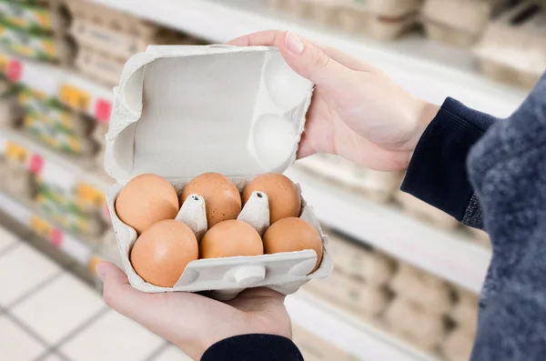Adam yumurta süpermarkette satın alır. — Stok fotoğraf