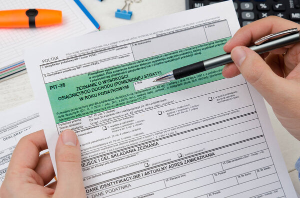 Man holding polish tax form PIT-36