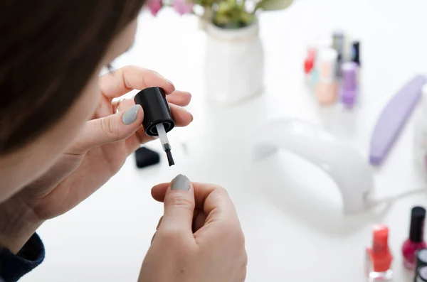 Woman painting her finger nails