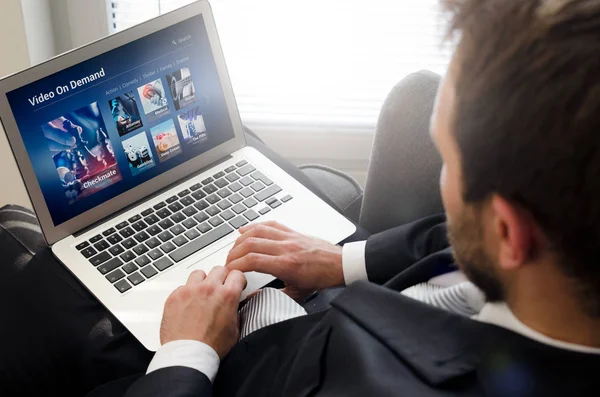 Man using laptop for watching movie on VOD service. — Stock Photo, Image