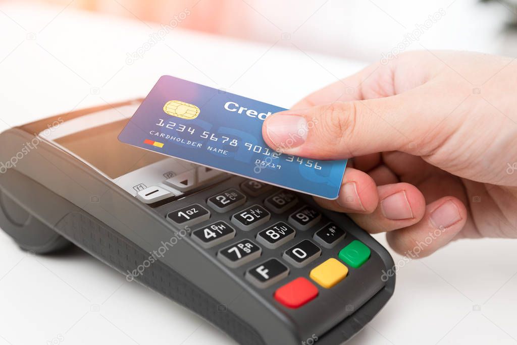 Man using credit card in shop
