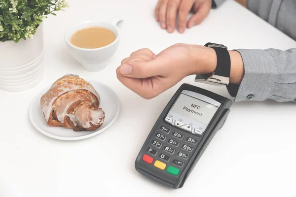 Man using smart watch to pay in restaurant — Stock Photo, Image