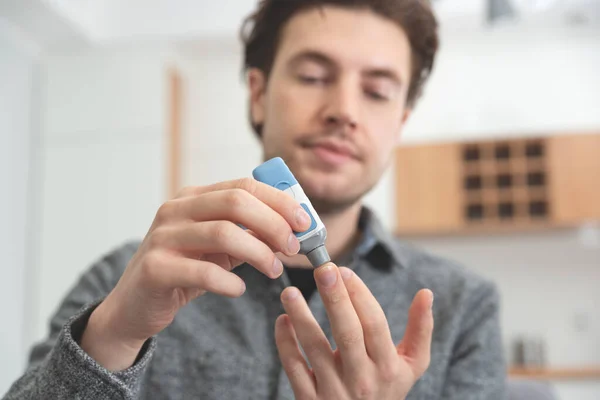 Young Man Measures Blood Sugar Level Diabetes Using Lancet — Stock Photo, Image