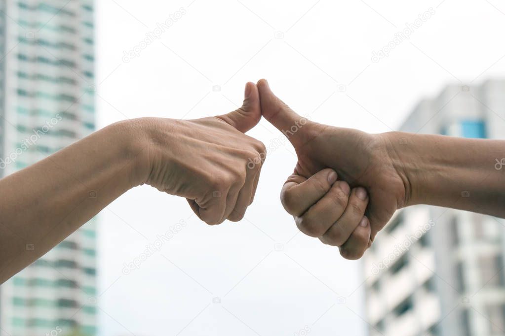 Hand of men giving Thumb finger like action and touching after agreement