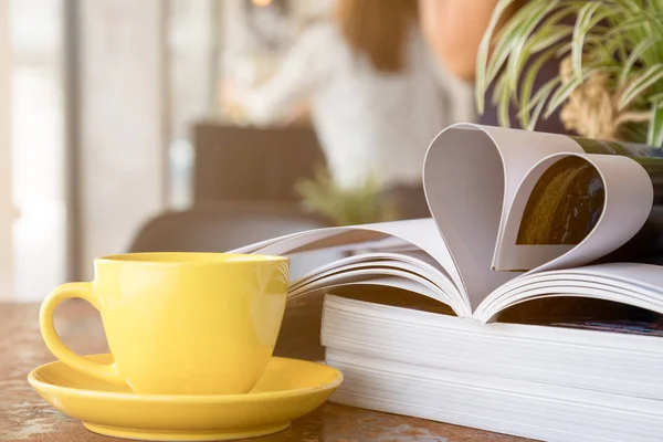 Close Yellow Coffee Cup Placing Together Magazine Heart Shape — Stock Photo, Image