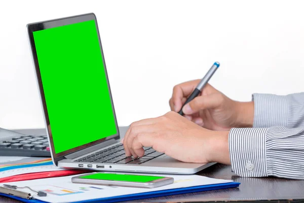 One businessman hold touched pen to check the data of  the sale volume report from green screen laptop on white background