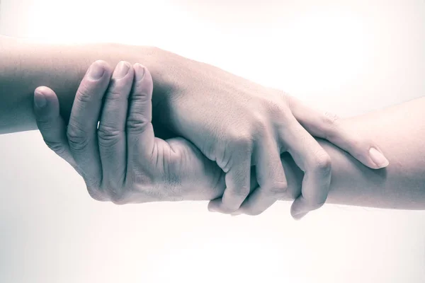 Two men holding hand together on white background