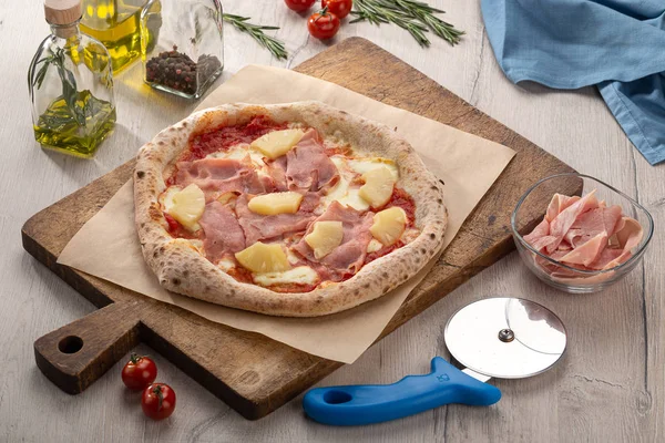 Delicious fresh pizza on table. pizza Hawaiian with pineapple and ham. Homemade delicious italian pizza on wooden table for dinner. Italian cuisine.