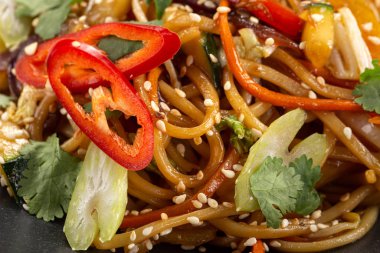 Soba eriştesi ve sebzeyle kızart. Sağlıklı Asya yemekleri, kase içinde kızarmış yemek. Baharatlı erişte. Vejetaryen Erişte veya Sebze Hakka Eriştesi veya Chow Mein. Hint-Çin mutfağı sıcak yemek.
