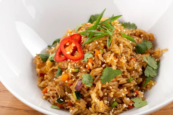 Thai food fried rice with egg. Asian cuisine-Homemade egg fried rice served with vegetables. Fried rice with vegetables, pepper, carrot, parsley, onion, chilli. Indo-chinese cuisine hot dish