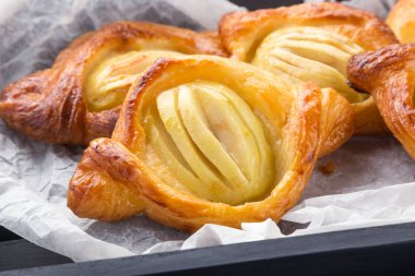 Meyveli, reçelli, böğürtlenli ve mavi peçeteli. Tahtada puf böreği ve siyah ahşap bir masa. Taze Fransız Fırınlanmış Puf böreği. Ev yapımı kekler ve puf börekleri. Sıcak Taze Tereyağı Yuvarlakları.