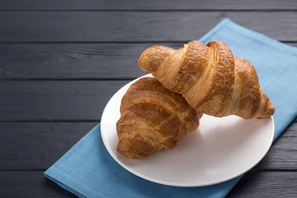 Croissants White Plate Black Wooden Table Served Blue Napkin Fresh — Stock Photo, Image