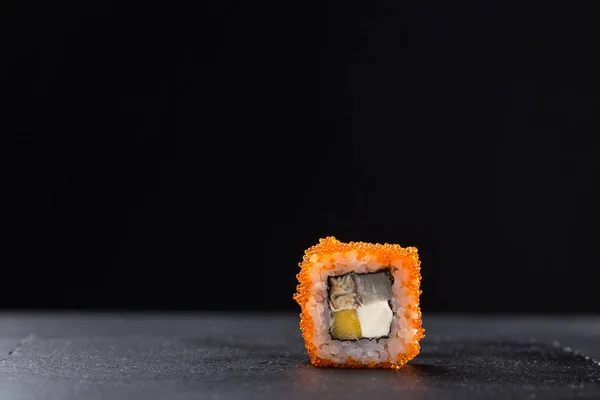 Sushi set. maki, gunkan and sushi rolls served on stone slate. Sushi set on a stone plate and dark concrete background. Sushi roll set and chopsticks. Fresh Japanese cuisine. asian food. Sushi image for menu. close up