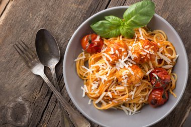 Geleneksel İtalyan makarnası eski ahşap bir masada servis edilir. Köfteli makarna, parmesan peyniri ve otlar. Ev yapımı lezzetli İtalyan geleneksel makarnası kırsal bir masada akşam yemeği için. İtalyan mutfağı..