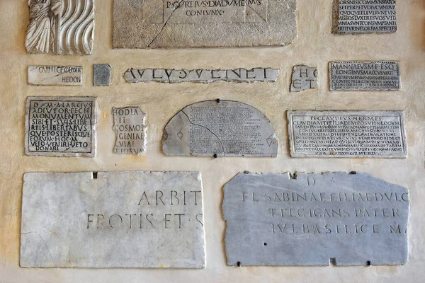 marble plaques with an inscription in Latin on the wall of the Basilica of Santa Maria in Trastevere, Rome