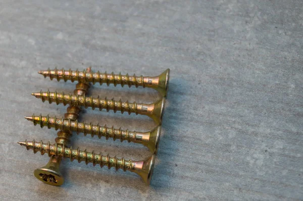 Screws in a row on a chair — Stock Photo, Image