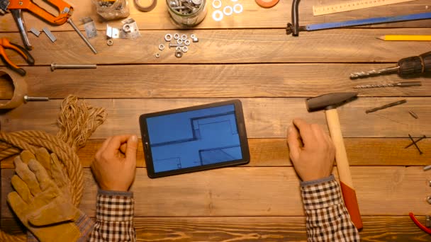 Craftsman using touch screen of tablet. Top view. — Stock Video