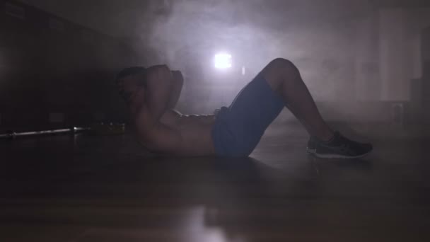 Man Doing Exercises Abs Smoke Backlight — Stock Video