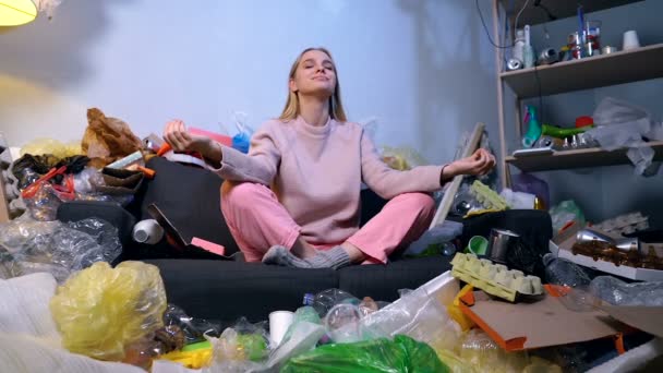 Woman Meditaiting Room Full Trash Gsrbage Pollution Problem Concept — Stock Video