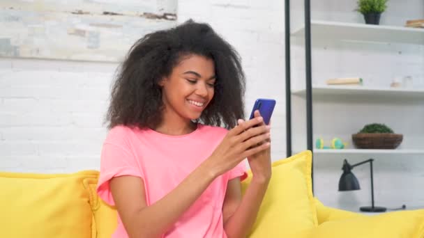 Smiling Happy Afro American Woman Sitting Couch Using Mobile Phone — Stock Video