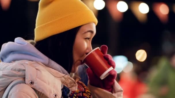 Gülen Asyalı Kadın Buz Pateni Pistinin Yanında Duruyor Sıcak Kahve — Stok video