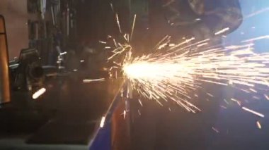 Worker using grinder tool and working with metal. A lot of aparks in slowmotion. Gimbal shot.
