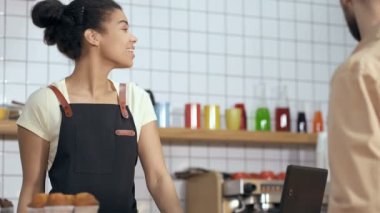 Garson, kahve dükkanında müşteriye servis yapıyor..