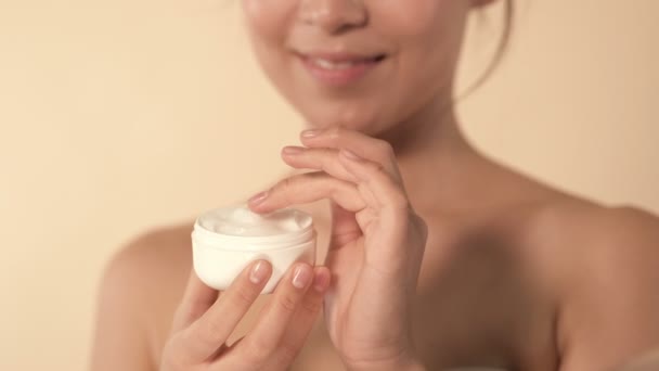 Close Portrait Young Woman Holding Jar Cream Hand Applying Cheek — Stock Video