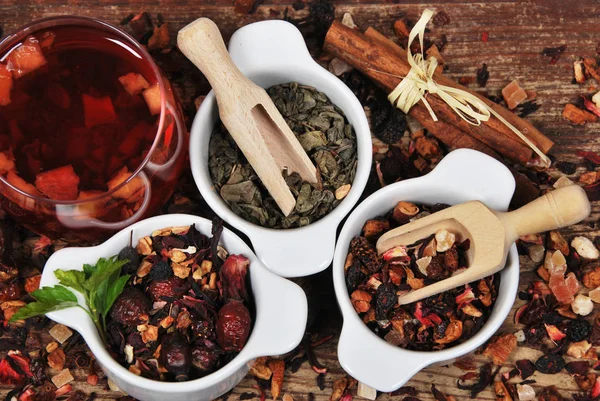 Fruit and green tea dried in white containers