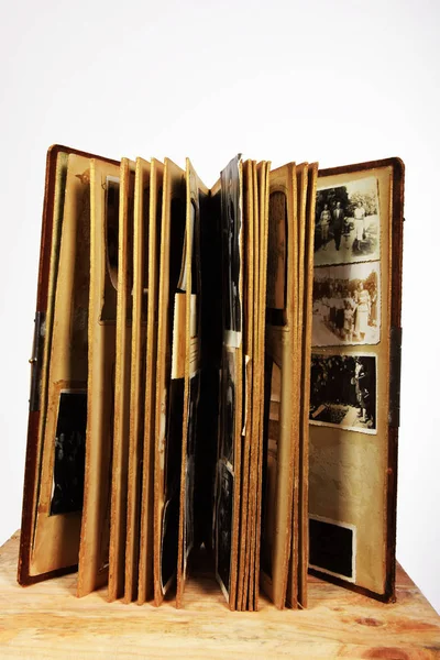 Old ruined photo album with old photos — Stock Photo, Image