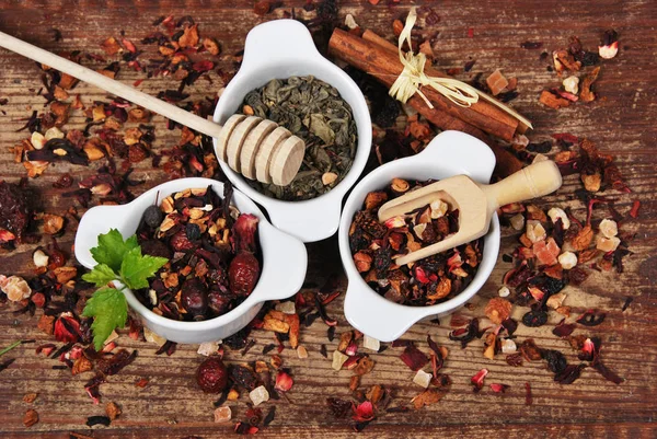 Fruit and green tea dried in white containers