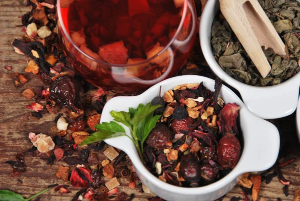 Fruit and green tea dried in white containers