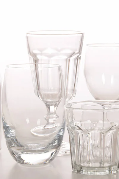 Empty crystal glasses and glasses and a bottle — Stock Photo, Image