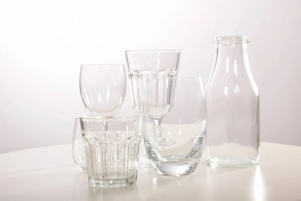 Empty crystal glasses and glasses and a bottle