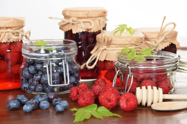 Blueberries and raspberries in jars for the winter tea — Stock Photo, Image