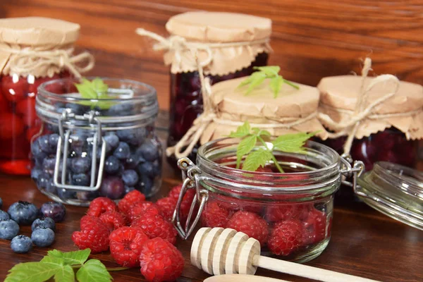 Blueberries and raspberries in jars for the winter tea — Stock Photo, Image