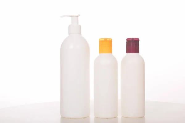 Cosmetics in bottles of plastic containers and tubes — Stock Photo, Image