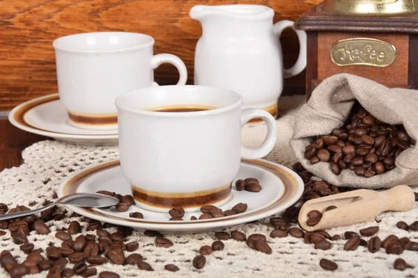 Tassen Kaffee und Milch und geröstete Kaffeebohnen — Stockfoto