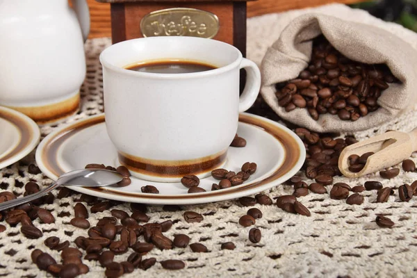 black coffee with chocolate cake next to a bag of coffee beans