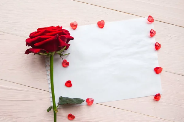Red rose and white mockup blank on wooden background. Valentine\'s Day or Wedding greeting card