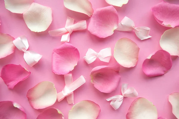pink and white rose petals on pink background.