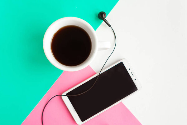 Flat lay photo with coffee cup and mobile phone on color background. 