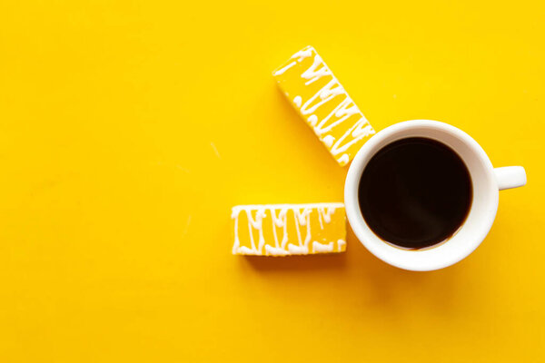 Delicious color bright cakes and coffee cup. Bright yellow background, minimal concept.