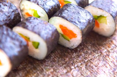  Sushi suşi ruloları, deniz yosunu arka planı, yakın plan, üst manzara.