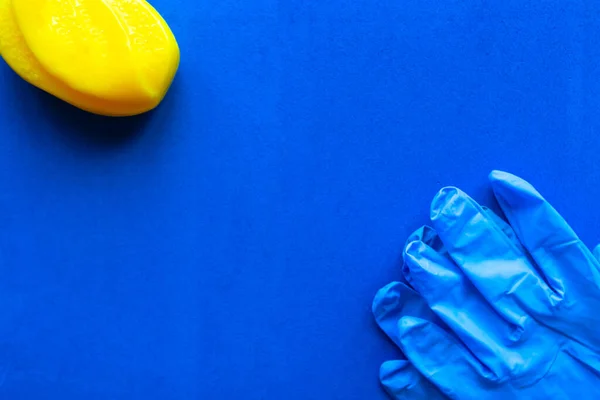 Soap bar and medical gloves on blue background. Copy space for the text. Covid-19 concept