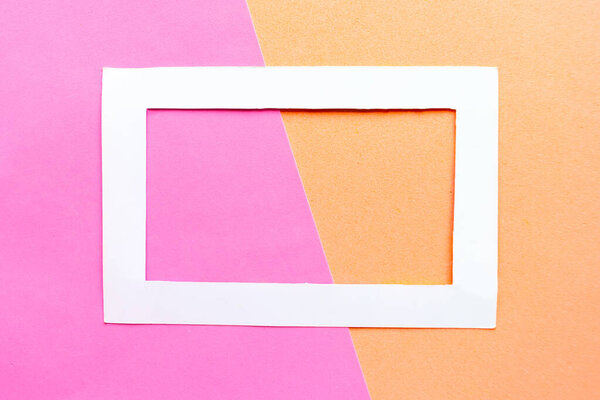 White photo frame on geometric color pastel background. Copy space for the text. Design concept