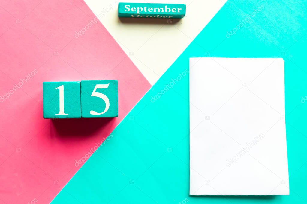 September 15. Wooden handmade calendar and white mockup blank on geometric white, pink and blue background