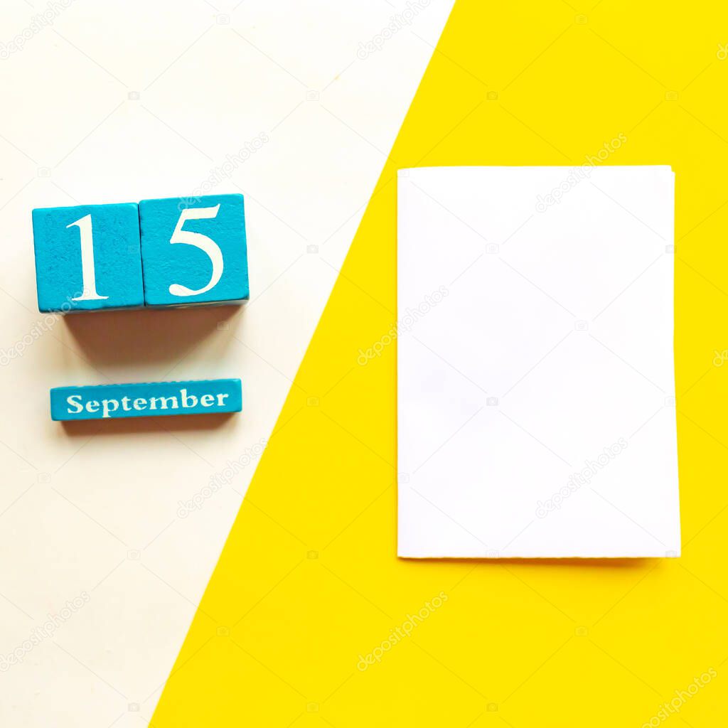 September 15, empty yellow and white geometric background and white mockup blank. Wooden handmade calendar