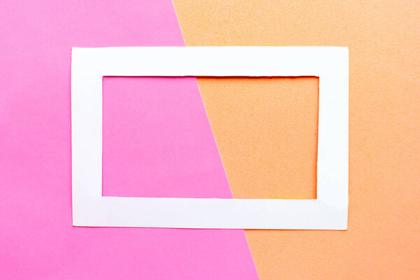 White photo frame on geometric color pastel background. Copy space for the text. Design concept