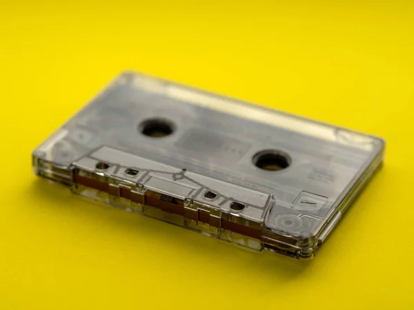 Audio cassette tape on yellow backgound.